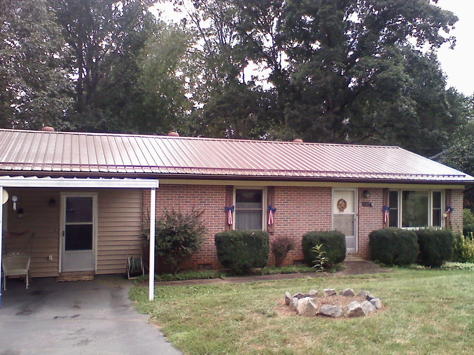 Bronze metal roof and carport on a brick ranch home — Roof Repair work by our crew in Harriman